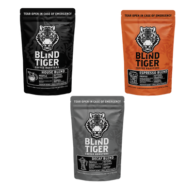 Three packages of Blind Tiger Coffee Roasters on a white background