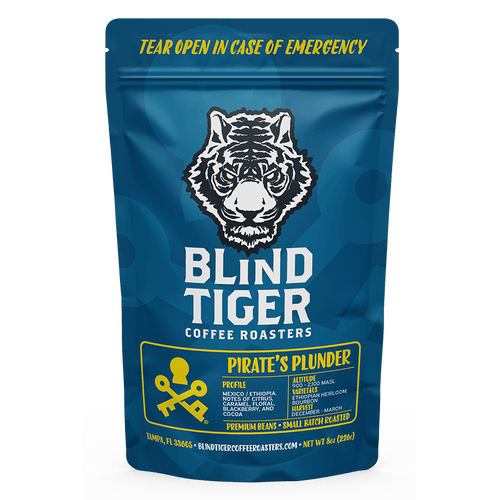 Blue coffee bag with Blind Tiger Coffee Roasters branding and a tiger logo.